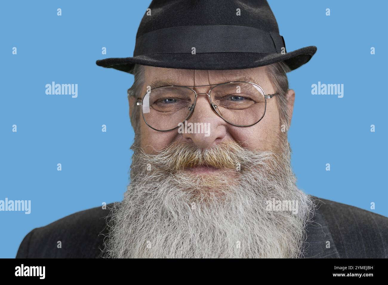 Close up face of senior long-bearded man. Isolated on blue Stock Photo