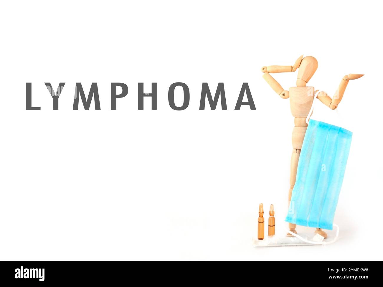 Man is holding a blue face mask and the word lymphoma is written below him. Concept of seriousness and concern, as the man is wearing a mask which is Stock Photo