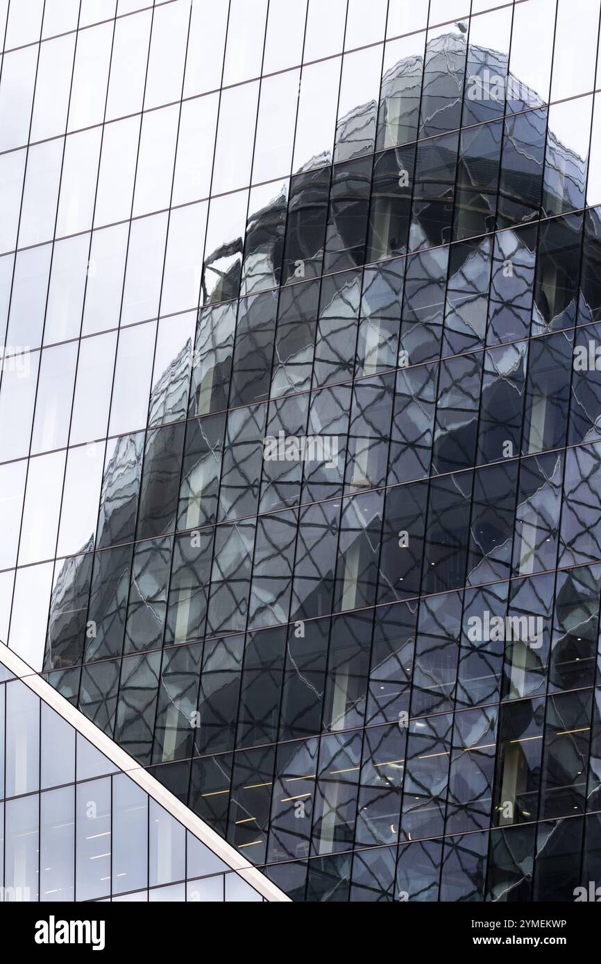 Skyscraper with reflective glass panels showing distorted reflections ...