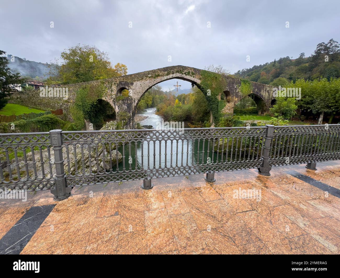 Roman Bridge with the Victory Cross, Asturias symbol, over the River Sella in the town of Cangas de Onís, Asturias, Spain - Smartphone Captured Stock Image