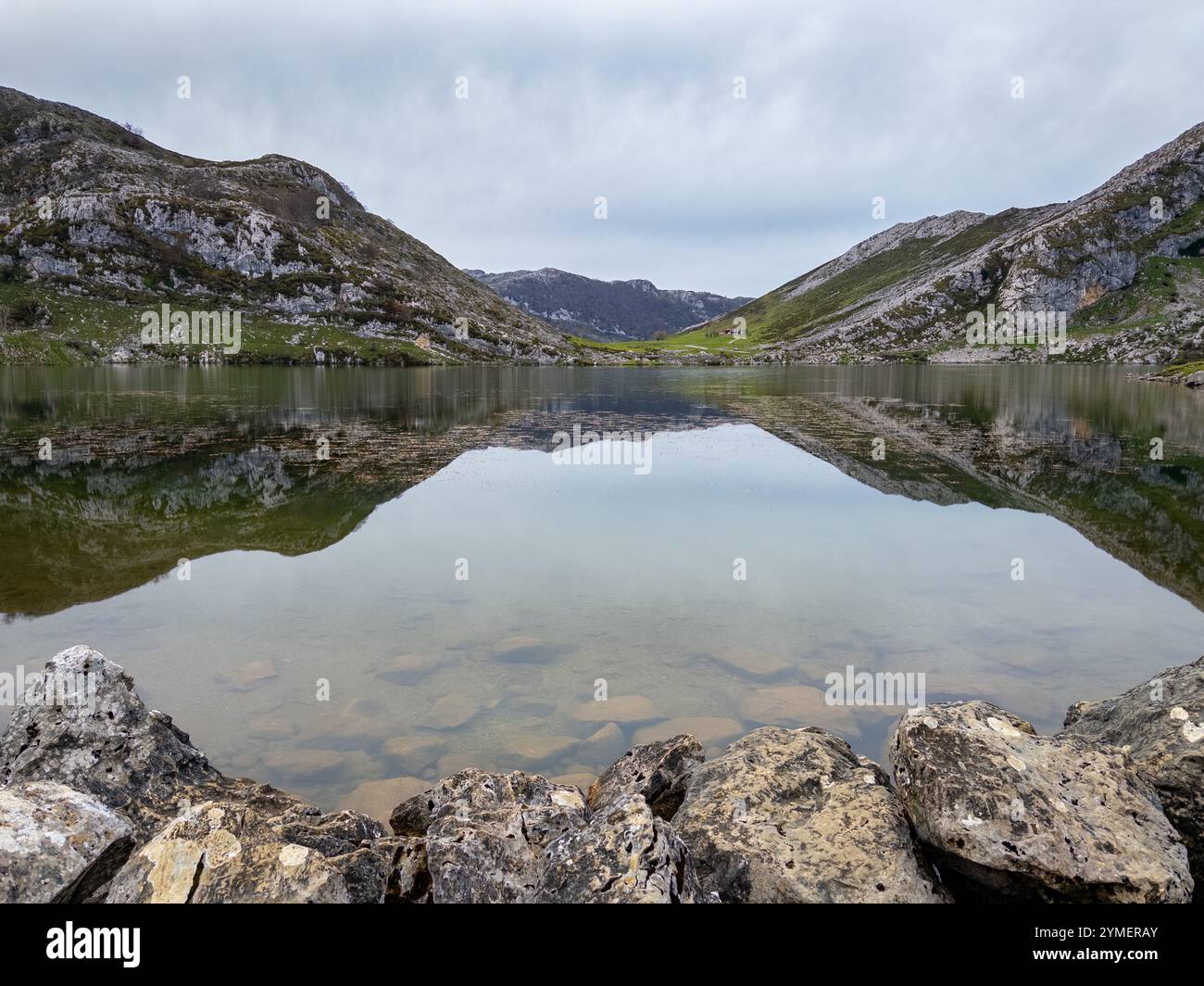 The calm waters of Lake Enol make a perfect mirror in the magnificent Picos de Europa National Park, Asturias, Spain - Smartphone Captured Stock Image