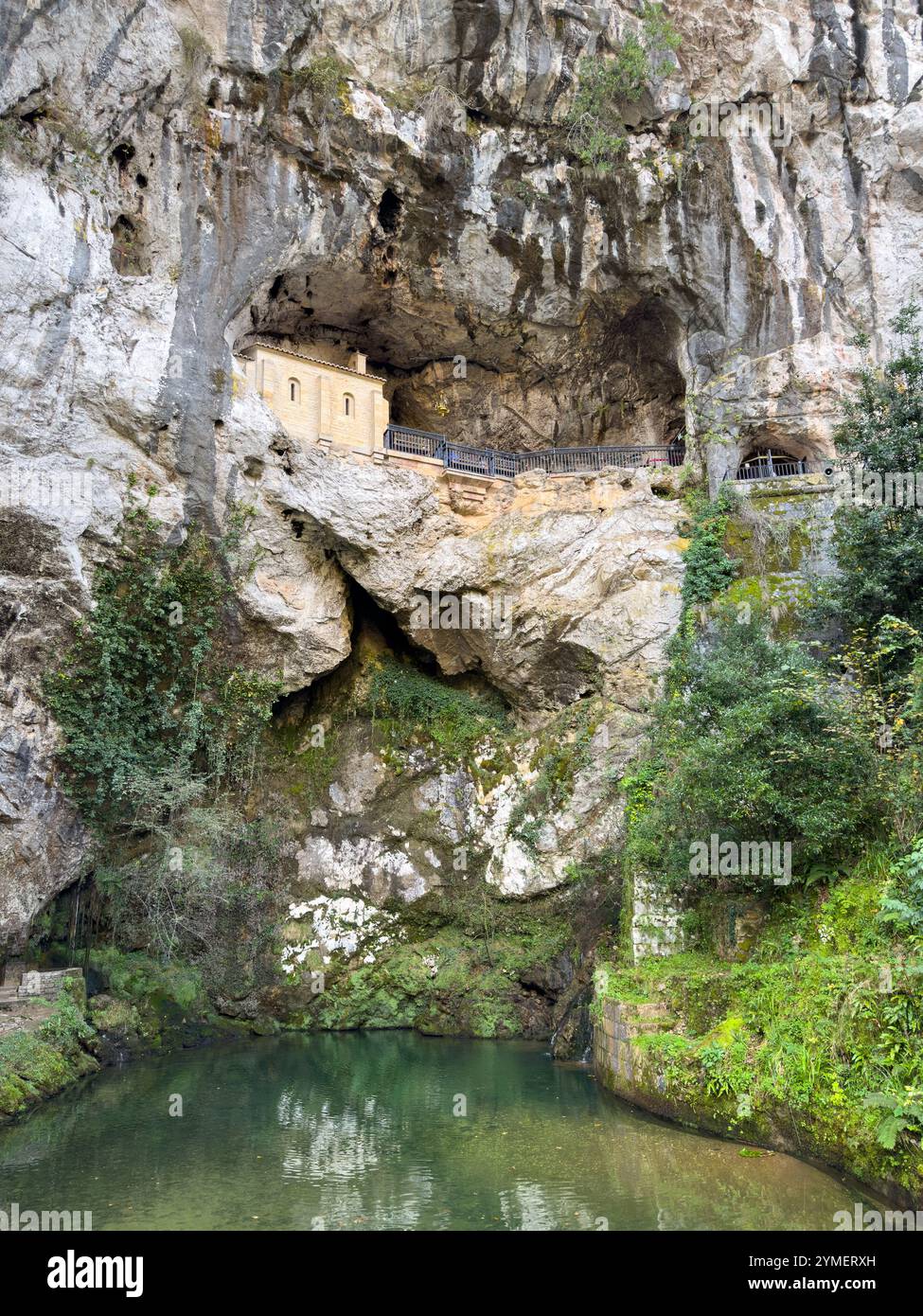 The Holy Cave of Covadonga with the fountain of the seven spouts in the lower left corner, Asturias, Spain - Smartphone Captured Stock Image