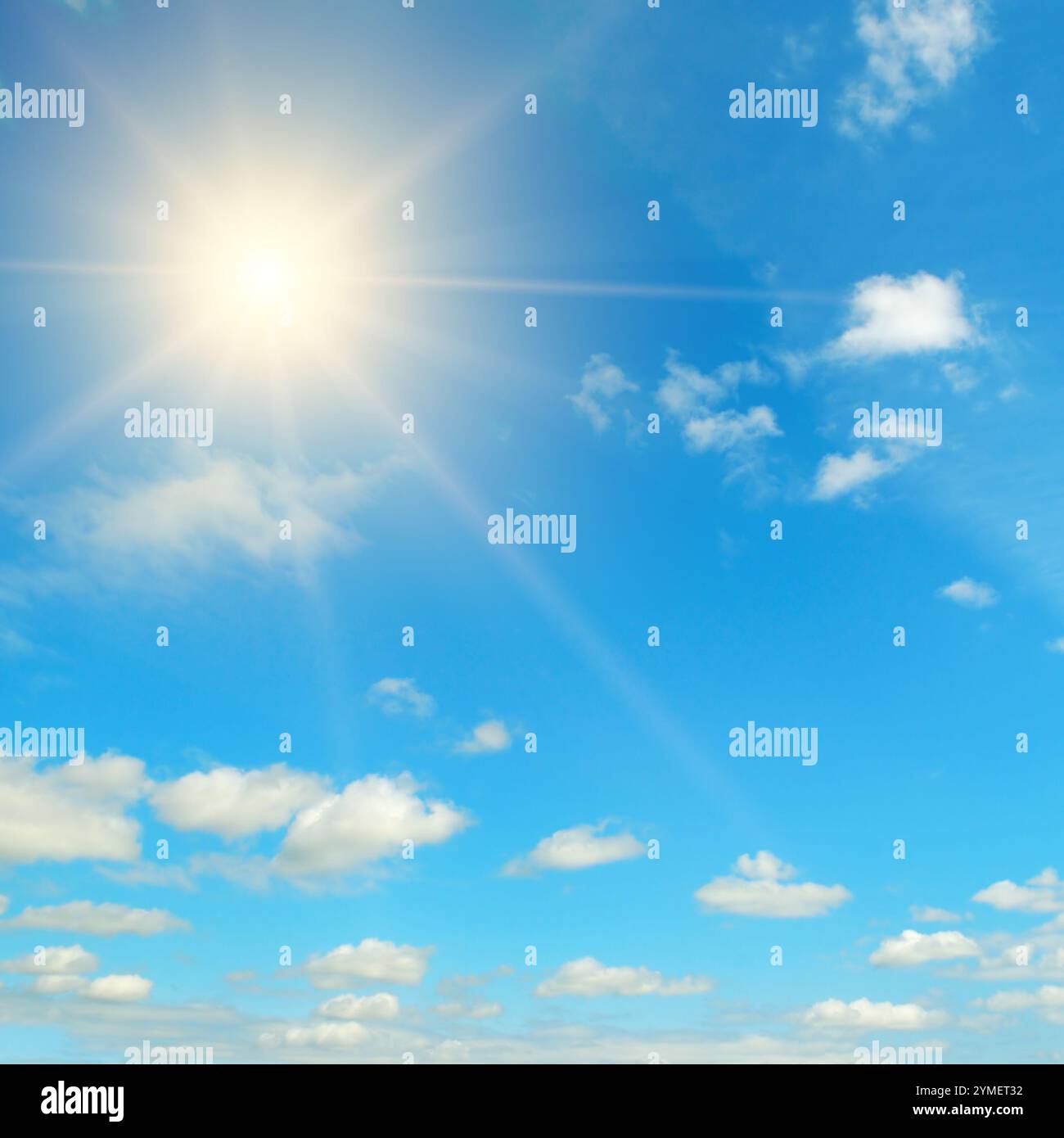 Couds in the blue sky. Bright midday sun illuminates the space. Stock Photo