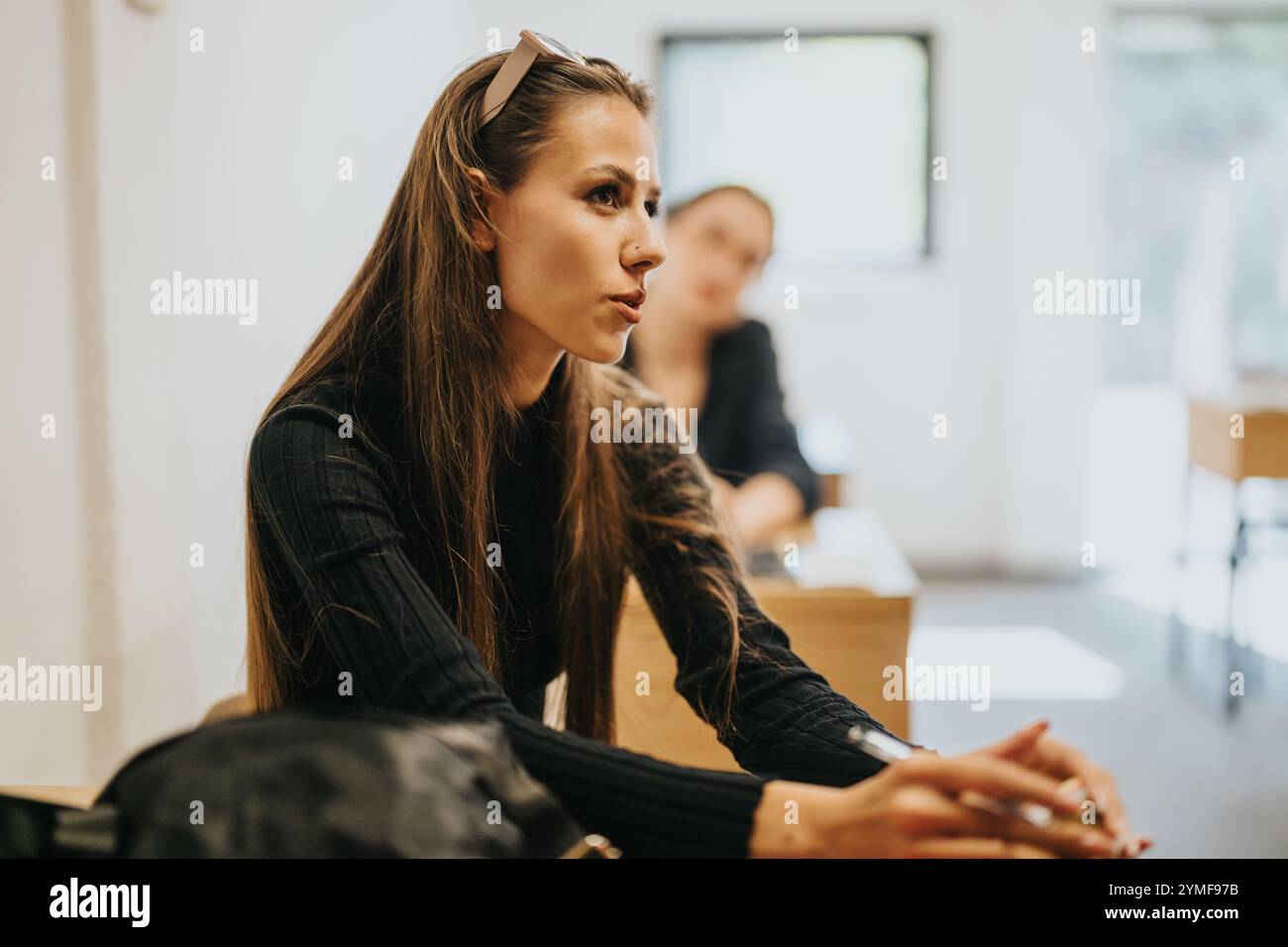 Engaged high school students participating in an interactive classroom discussion Stock Photo