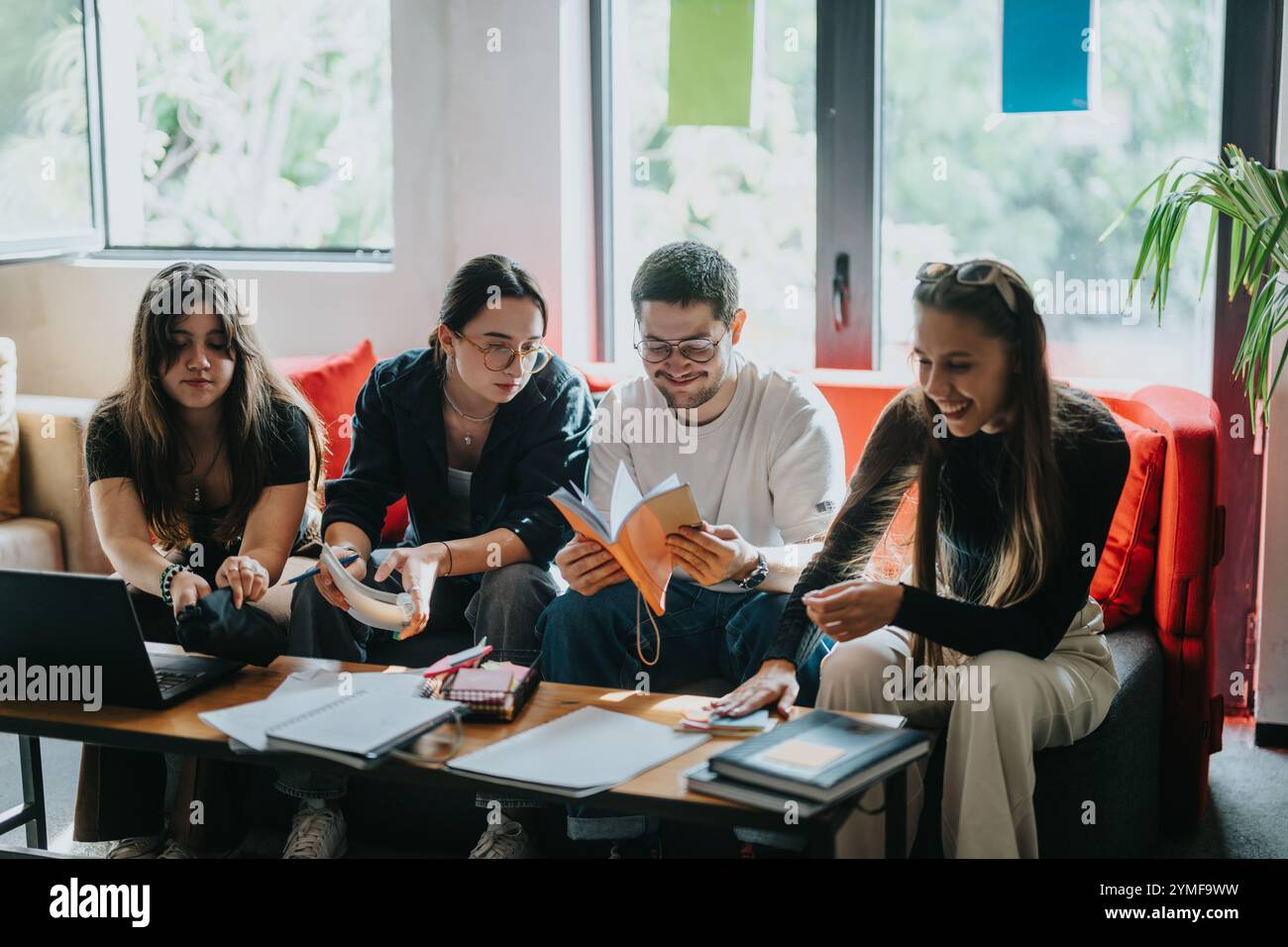 Students collaborating on school projects in a cozy study space Stock Photo