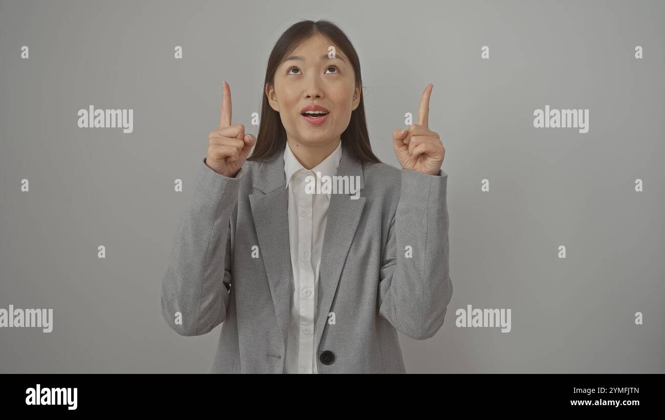 Asian woman pointing upwards hi-res stock photography and images - Alamy