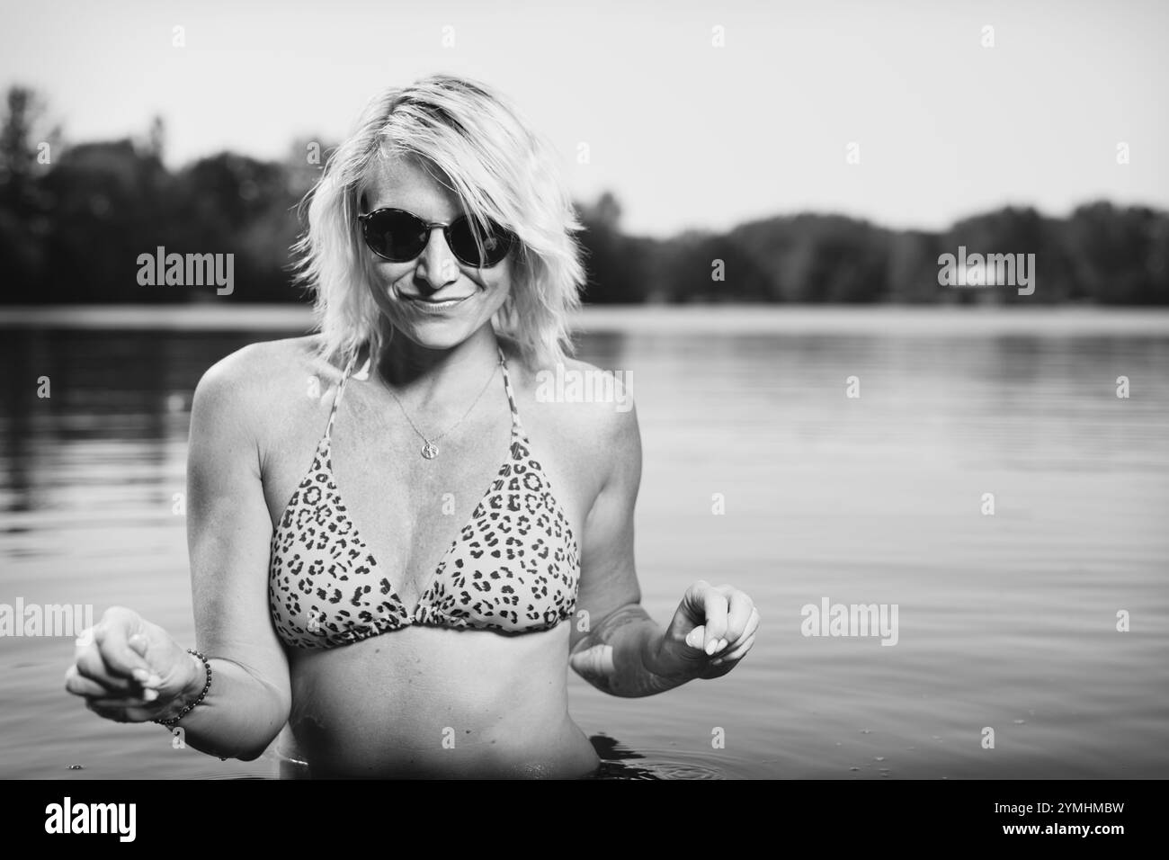 Pretty lady in summer lake posing for portrait in daytime Stock Photo
