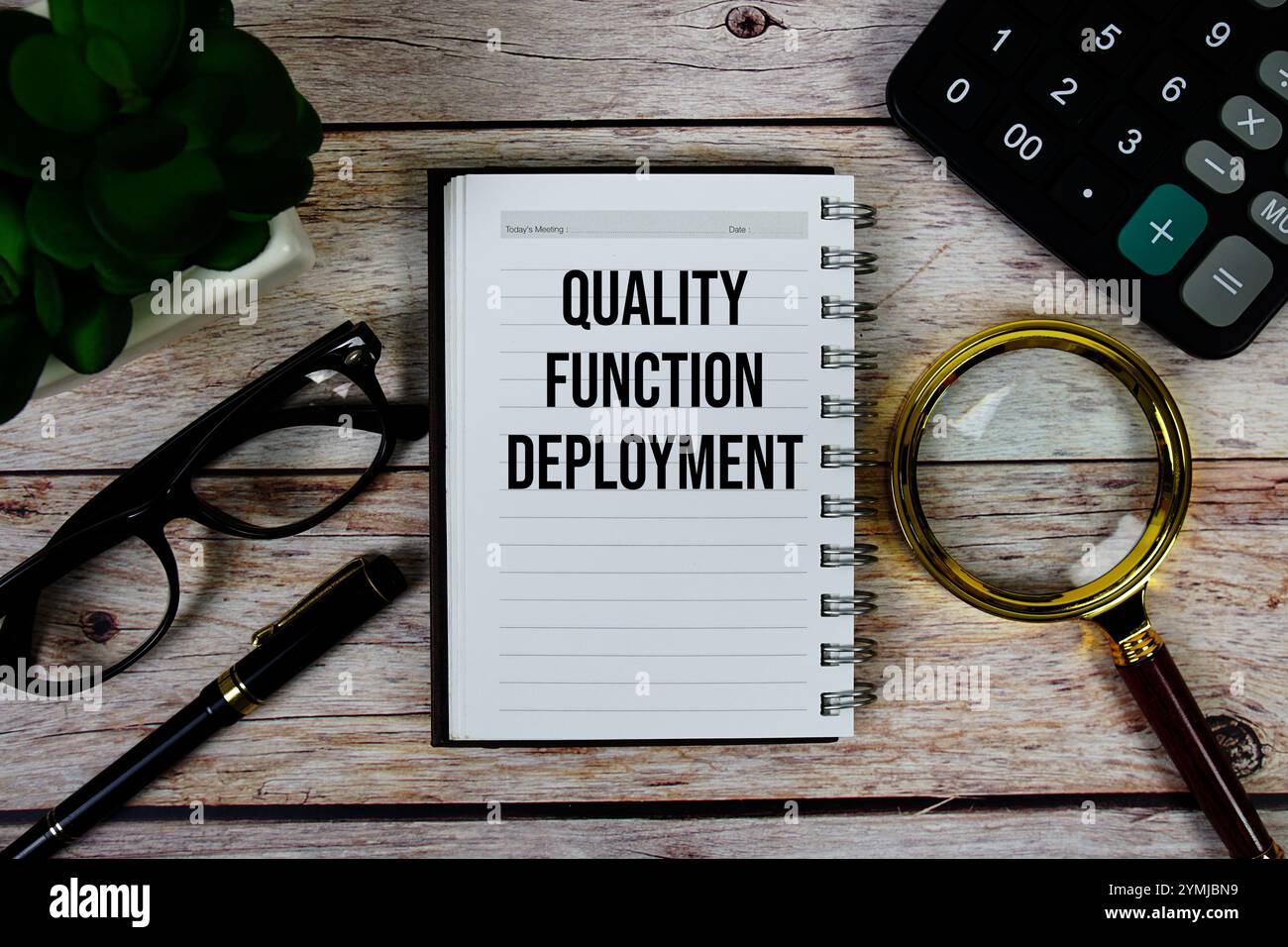 Quality Function Deployment (QFD) text on notepad, Business and ...