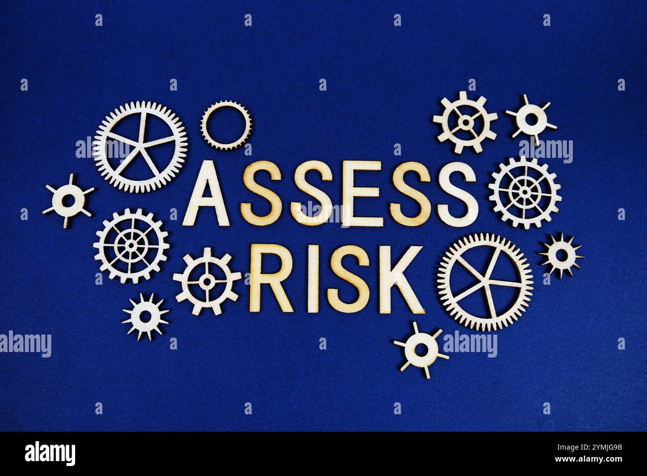 Assess Risk alphabet letters with gears element on navy blue background ...