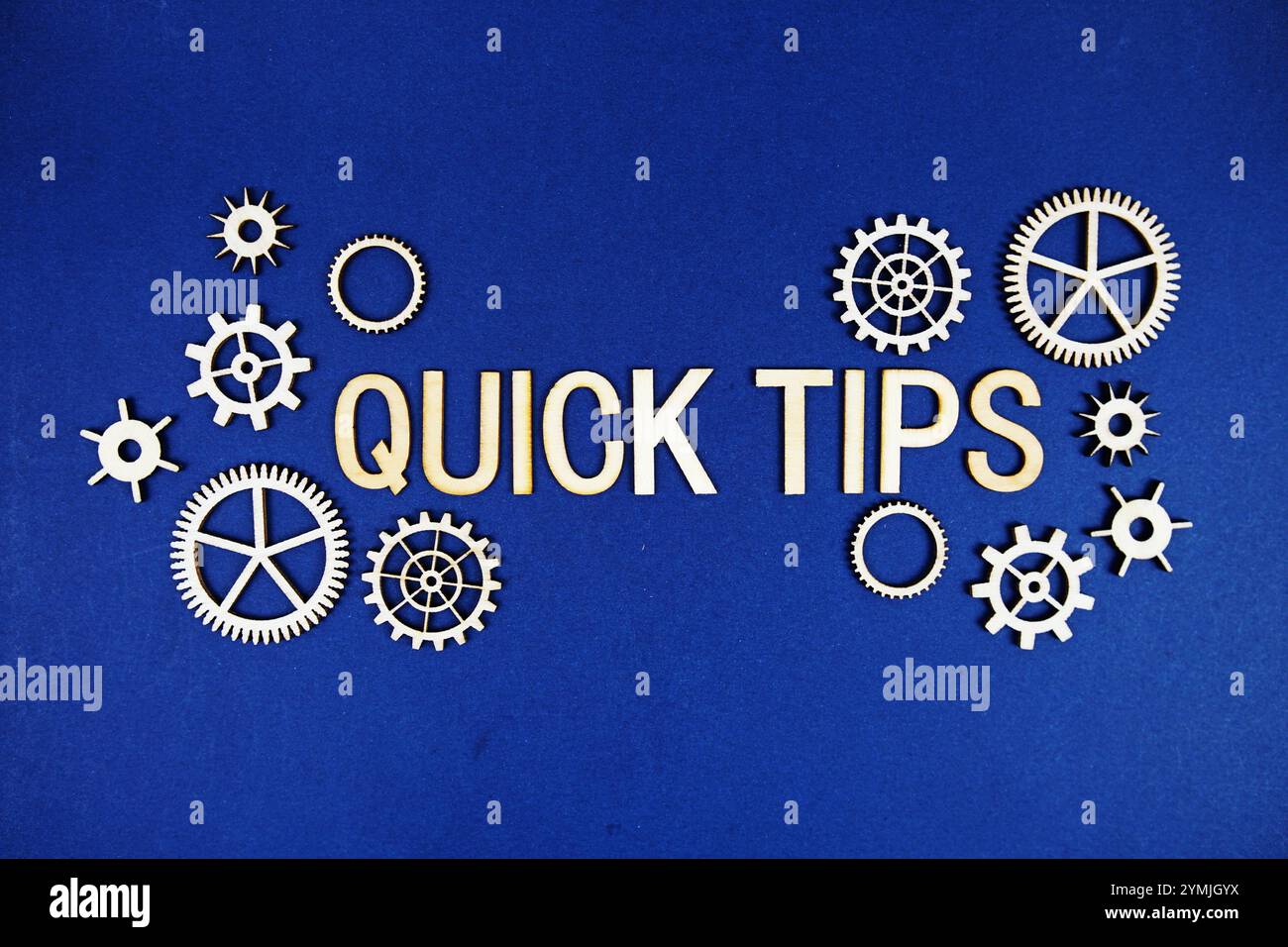 Quick Tips alphabet letters with gears element on navy blue background Stock Photo