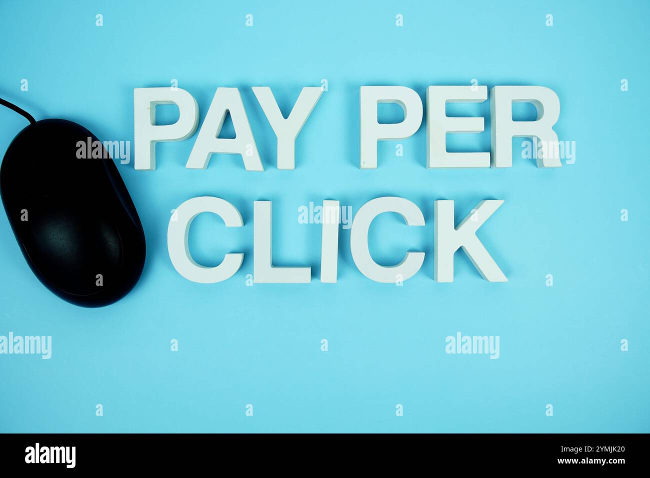 Pay Per Click alphabet letters and optical mouse top view on blue ...