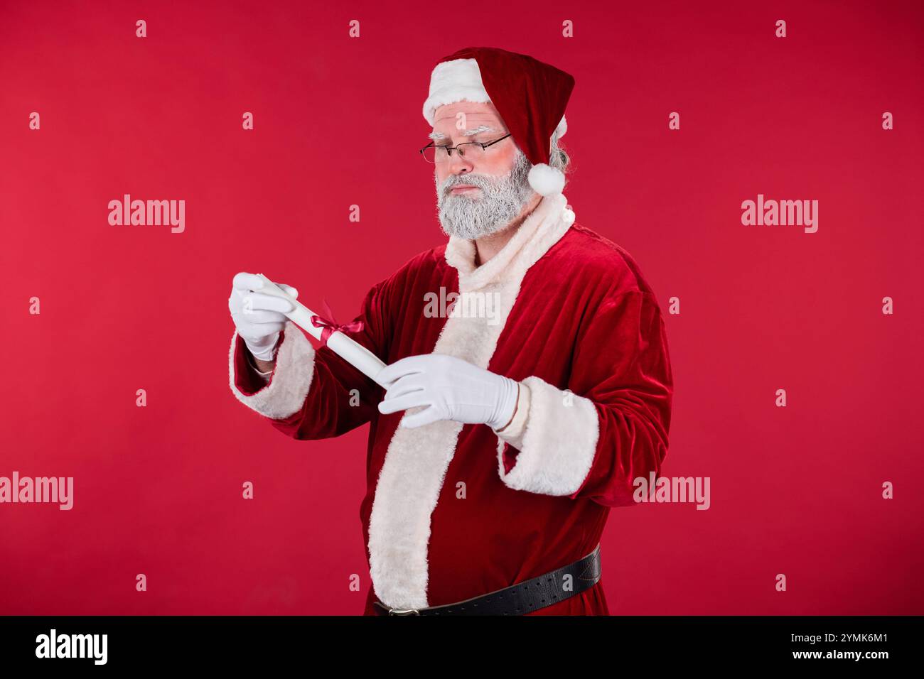 Santa Claus dressed in traditional red and white attire with glasses ...