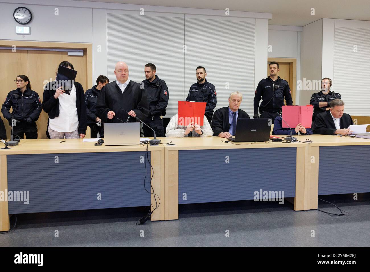 22 November 2024, Lower Saxony, Osnabrück: Three defendants can be seen alongside their defense lawyers in a courtroom at Osnabrück District Court. The public prosecutor's office is accusing the men, now aged 23 and 25, and the woman, now 27, of attempted joint manslaughter, dangerous bodily harm, extortion and robbery. They are said to have lured a 17-year-old girl into a forest near Meppen, assaulted her there and tied her up. The teenager was abused and injured for hours. Photo: Friso Gentsch/dpa Stock Photo