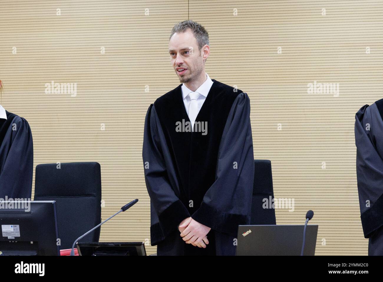 22 November 2024, Lower Saxony, Osnabrück: Presiding judge Daniel Hartmann stands in a courtroom at Osnabrück District Court. The public prosecutor is accusing three defendants of attempted joint manslaughter, grievous bodily harm, extortion and robbery. They are said to have lured a 17-year-old girl into a forest near Meppen, assaulted her there and tied her up. The teenager was abused and injured for hours. Photo: Friso Gentsch/dpa Stock Photo