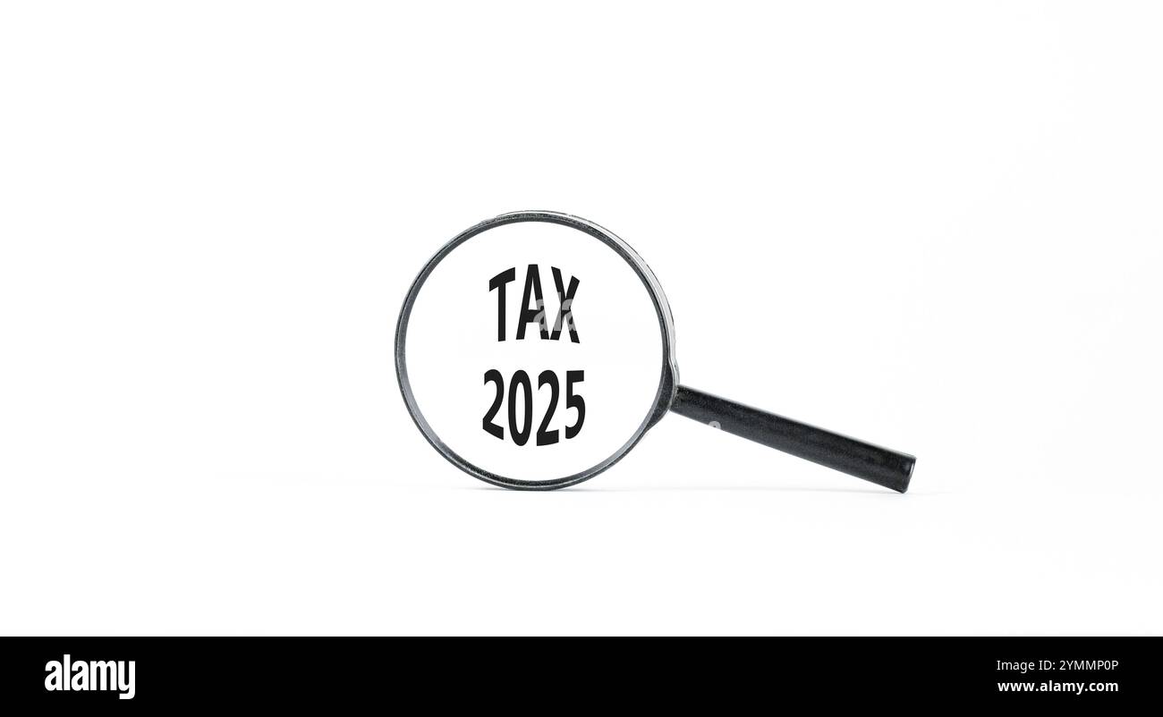Planning tax 2025 new year symbol. Concept words Tax 2025 on beautiful white paper in magnifying