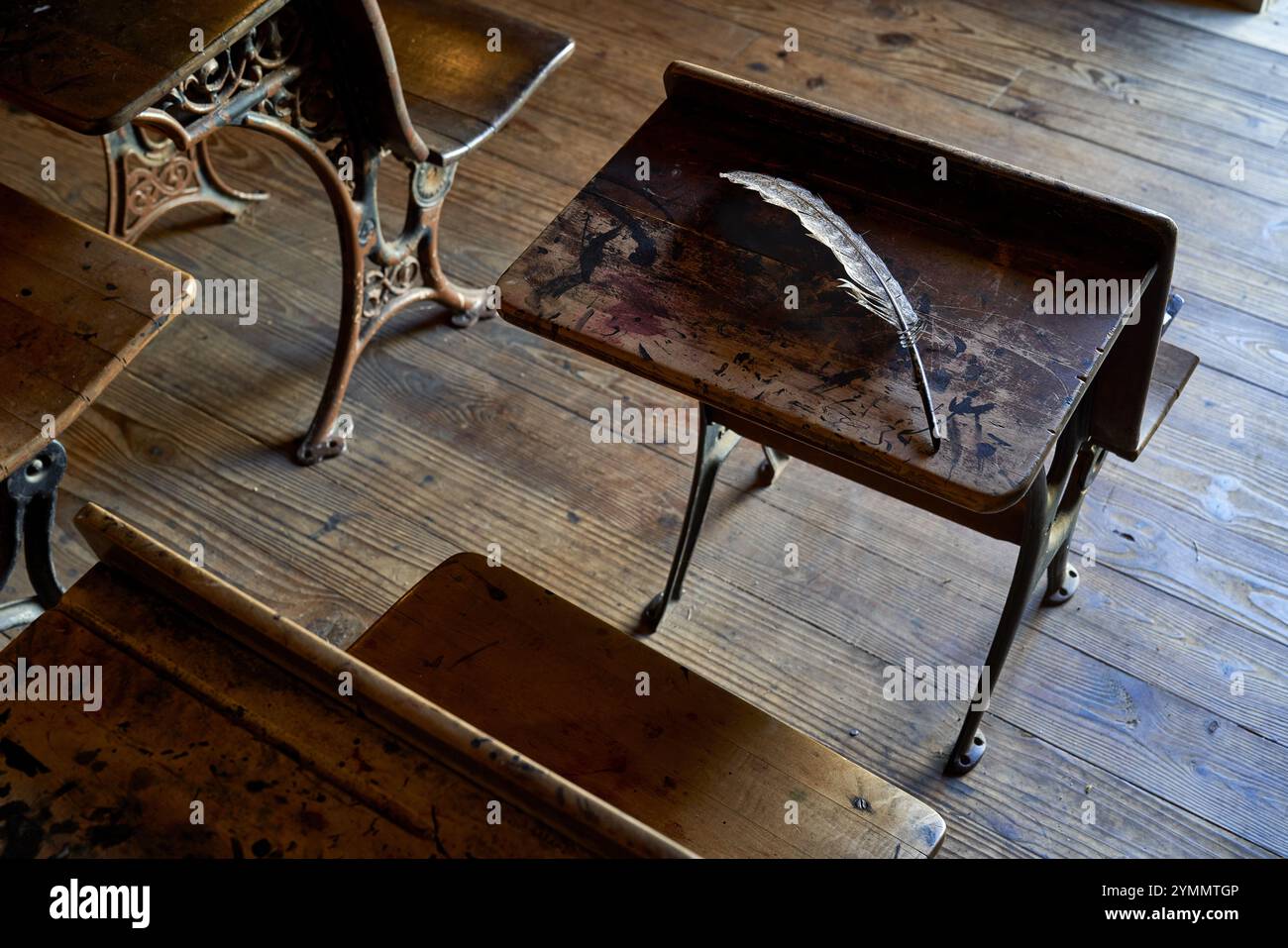 Old school room with feather pen on desk Stock Photo