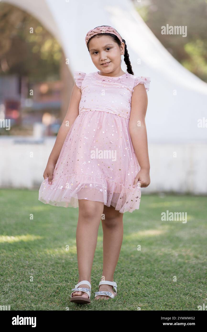 Little girl walking in the park in a pink dress Stock Photo - Alamy