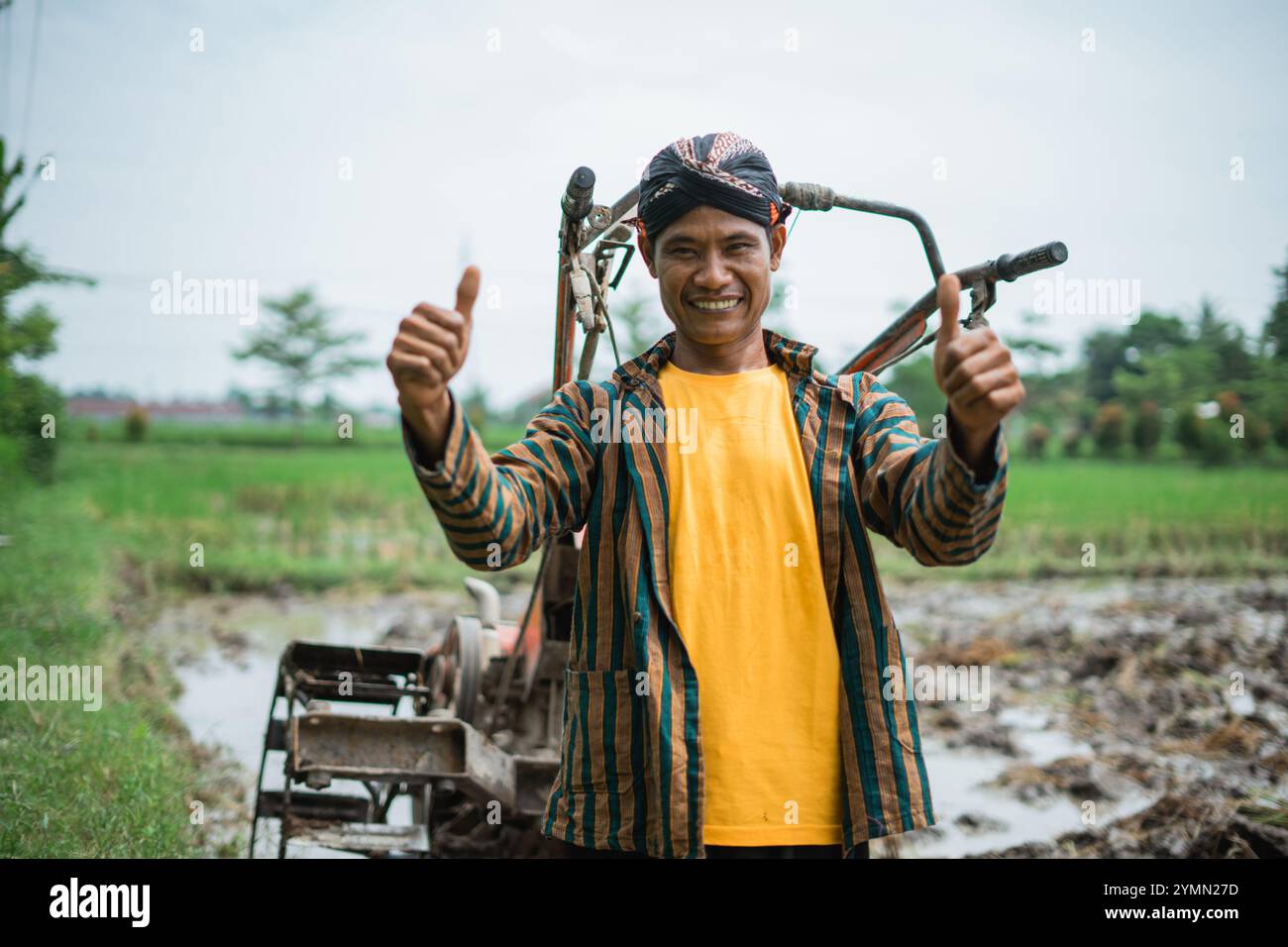 A Smiling Farmer Giving a Thumbs Up Gesture in a Beautiful and Lush ...