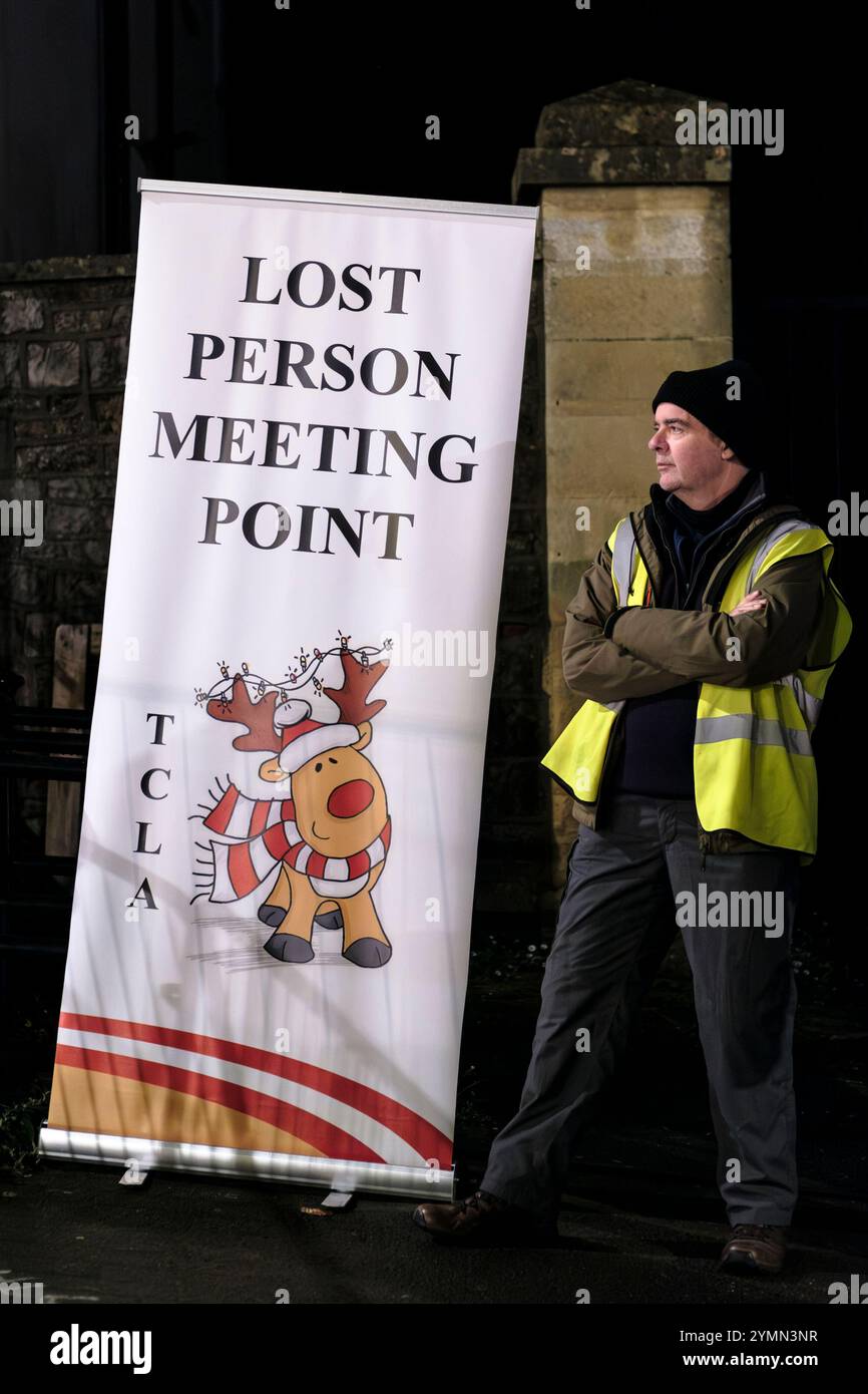 Man standing at the Lost Person Meeting point at the Thornbury christmas Light switsh on Stock Photo