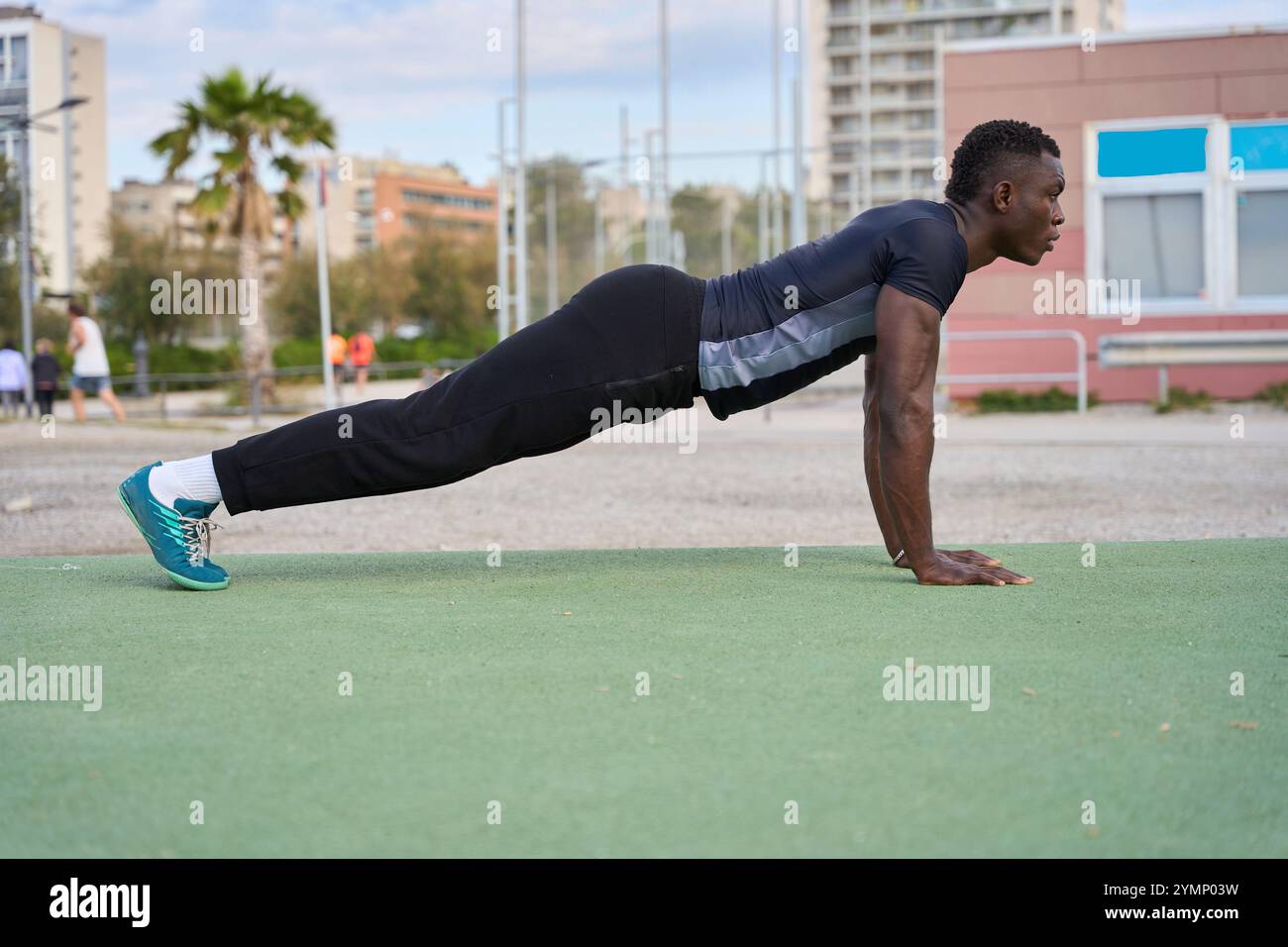Young black man doing push-ups outdoors in a calisthenics workout Stock ...