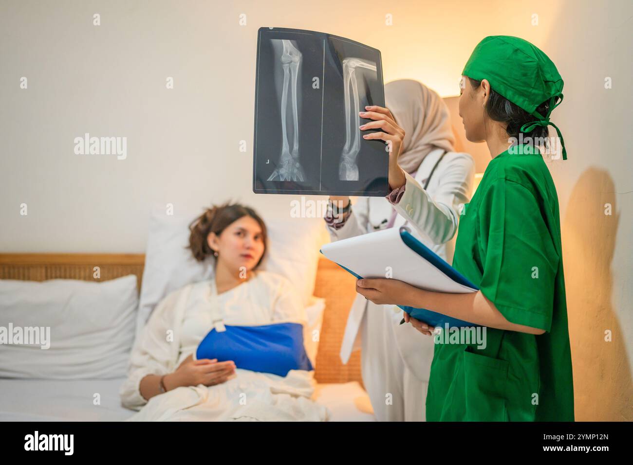 A medical team discusses Xray results and treatment options with a ...