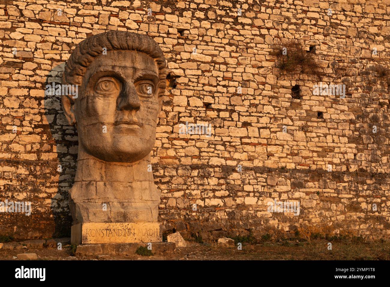 An outsized sculpture of the head of the Emperor Constantine the Great, photographed in the evening in the castle at Berat, Albania. Stock Photo
