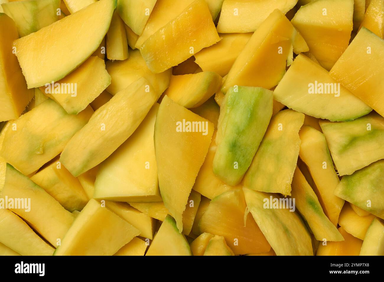 pile of chopped ripe mango, vibrant yellow juicy fruit pieces to ...