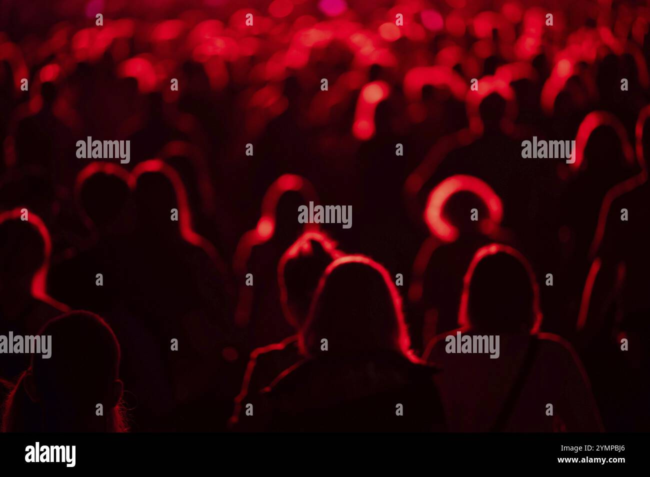 Crowd of people in front of the stage during the concert. Stock Photo