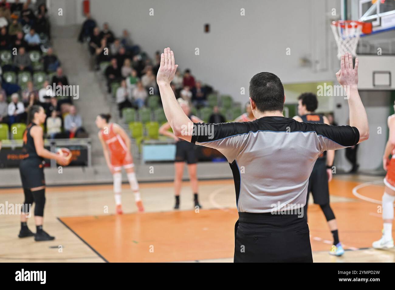 Throwing Refs Man referee shows the free throw with his hands. In the background ...