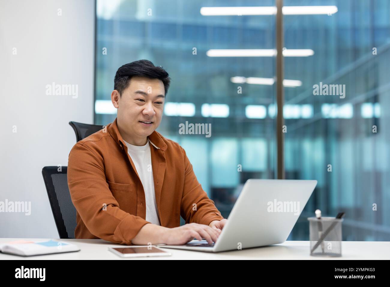 Asian programmer engaged in coding hi-res stock photography and images ...