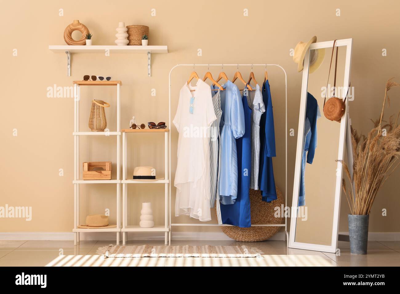 Rack with different stylish clothes and shelving unit with accessories ...