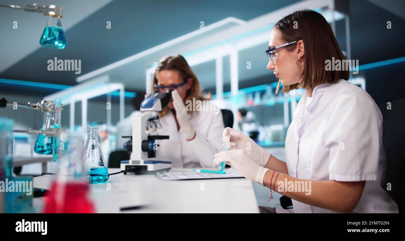 Medical Lab Scientist Woman Doing Research In Laboratory Using Microscope Stock Photo
