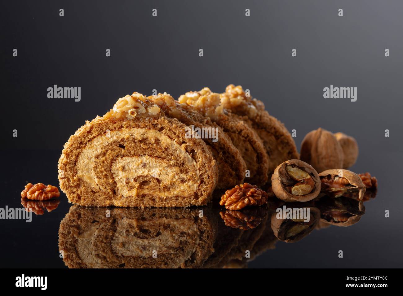 Dessert with walnuts on a black reflective background. Cake with brown sugar, walnuts, and cream. Copy space. Stock Photo