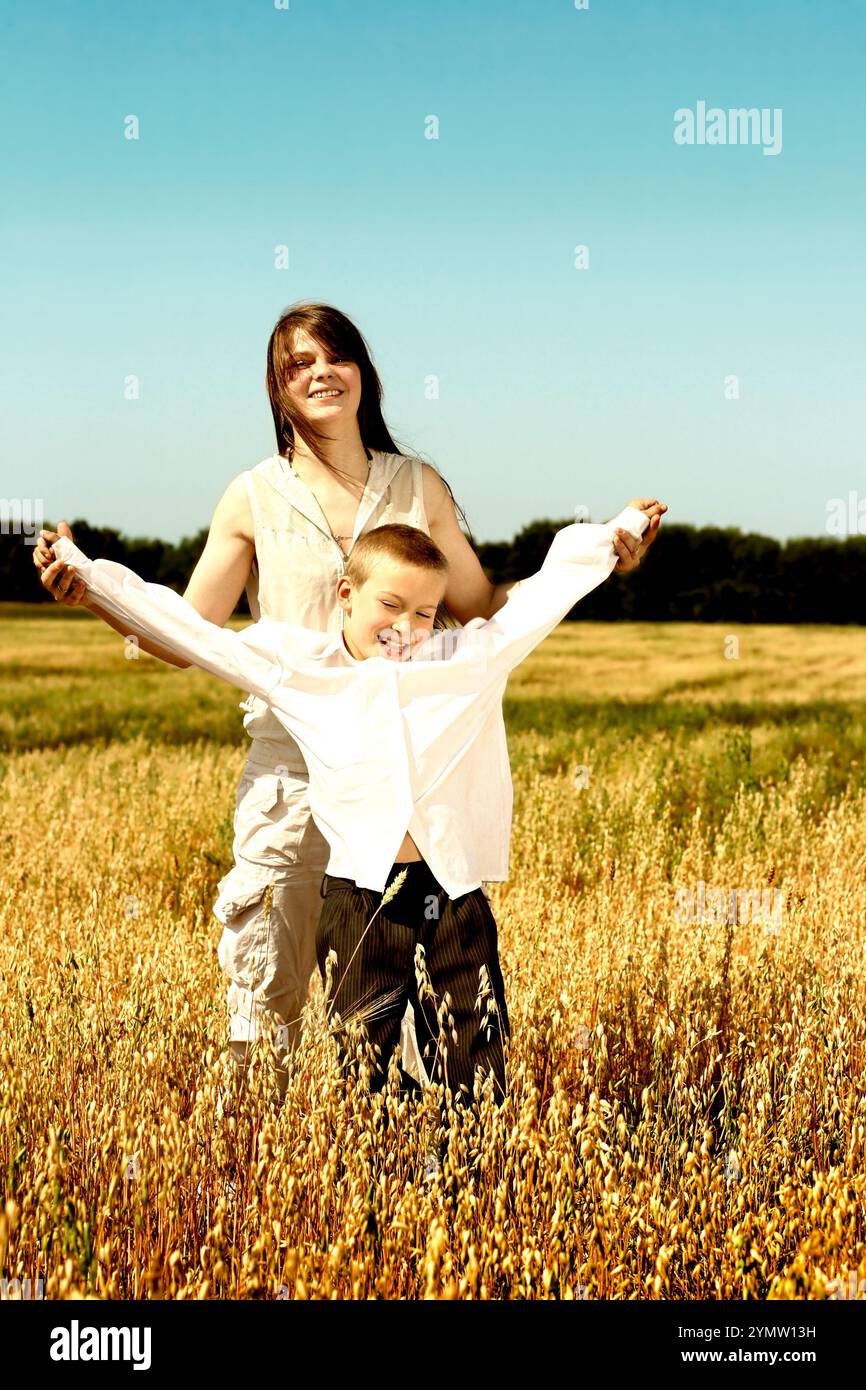 happy brother and sister in the summer field Stock Photo - Alamy