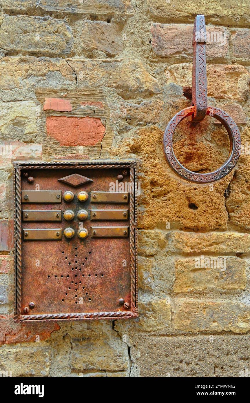 Ancient metal intercom with wrought iron horse tether, Siena, Tuscany, Italy Stock Photo