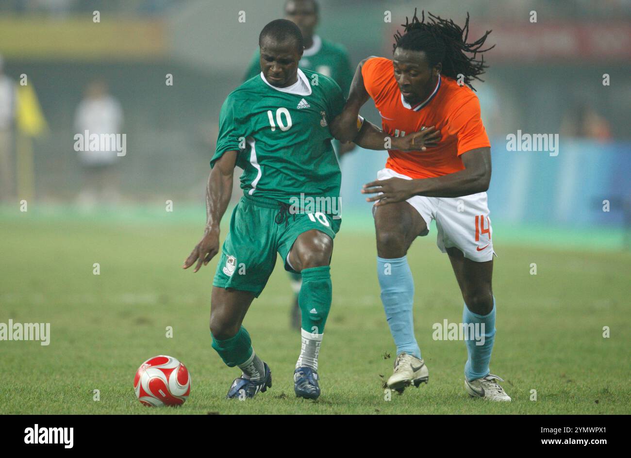 TIANJIN, CHINA - AUGUST 7:  Promise Isaac of Nigeria (l) and Evander Sno of the Netherlands (r) fight for the ball during a Group B match at the Beijing Olympic Games soccer tournament August 7, 2008 in Tianjin China. Editorial use only. (Photograph by Jonathan Paul Larsen / Diadem Images) Stock Photo