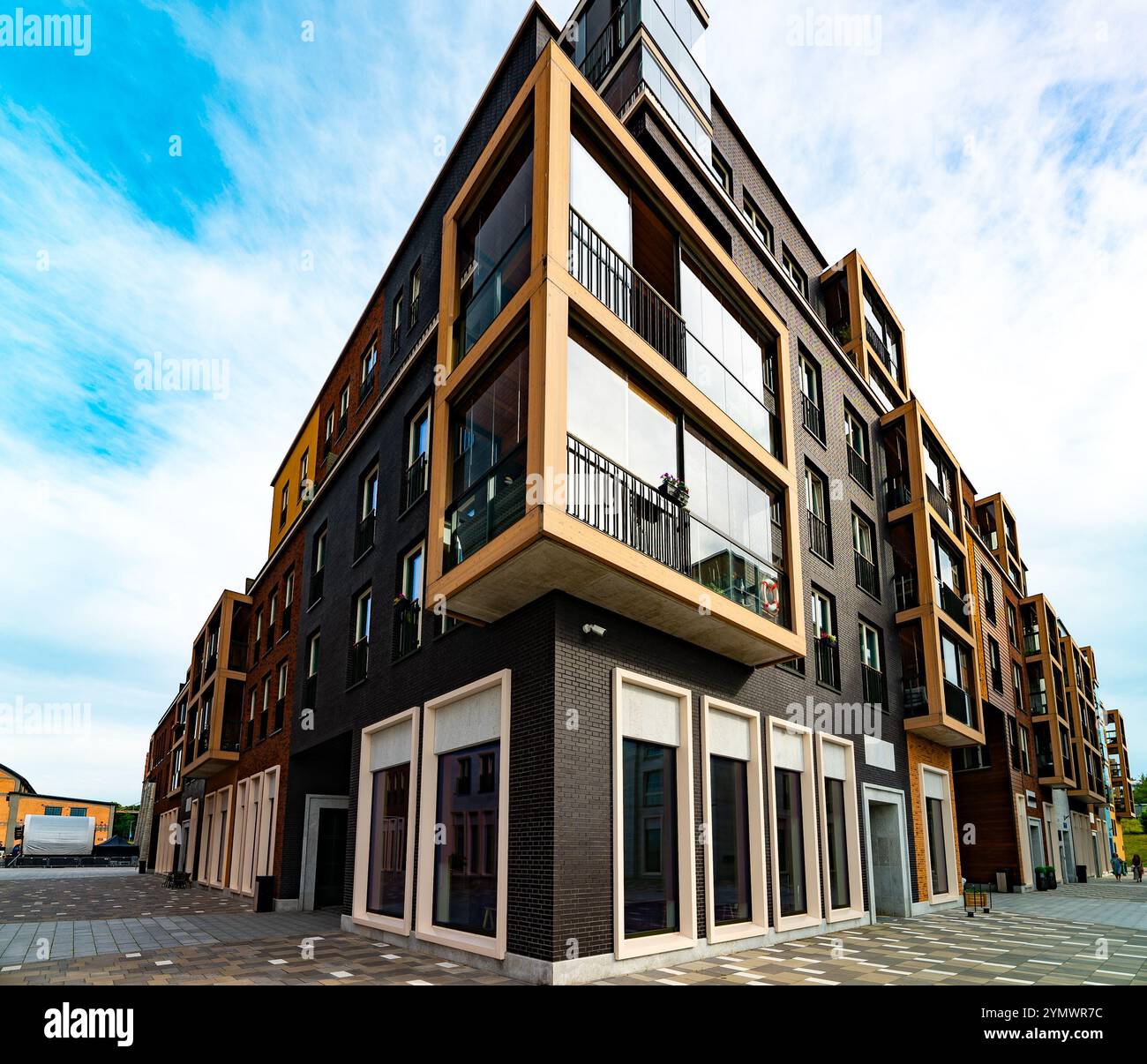 Modern Apartment Building with Glass Balconies and Industrial Elements ... - Industrial Glass Apartment Extension Design