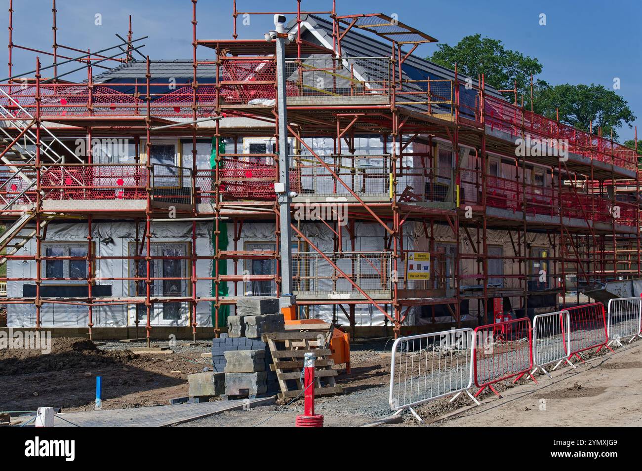 Scaffolding surrounding residential development for safe access to ...