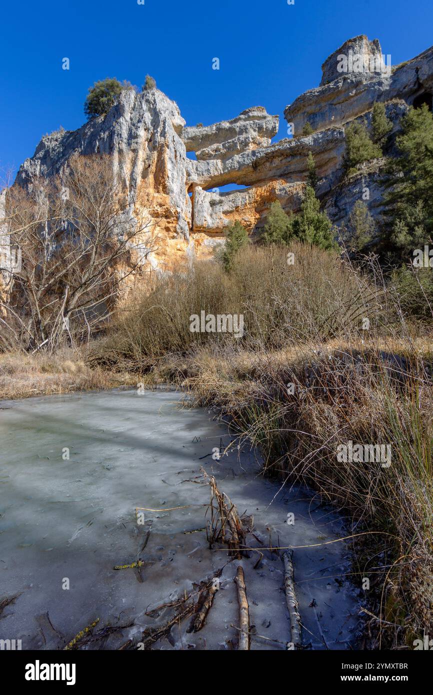 Rio Lobos canyon, iced river at winter. Romanesque church of St. Bartolome. Soria, Castilla y Leon, Spain Stock Photo