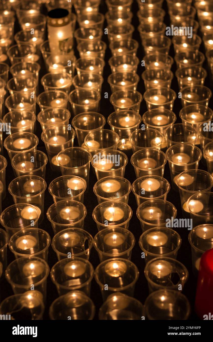 Lighted candles in cups, burning at night. Concept of memory and love ...