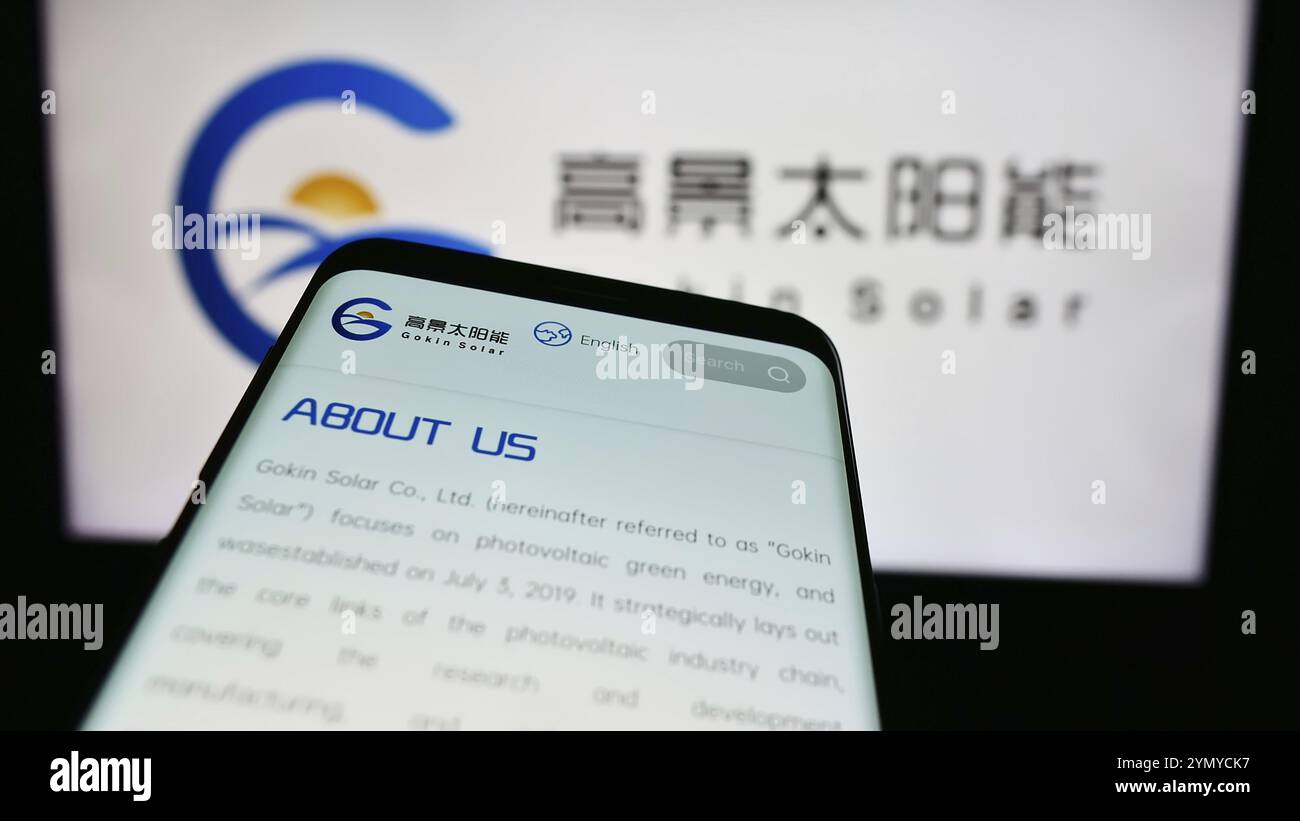 Stuttgart, Germany, 06-14-2024: Smartphone with website of Chinese photovoltaics company Gokin Solar Co. Ltd. in front of business logo. Focus on top- Stock Photo