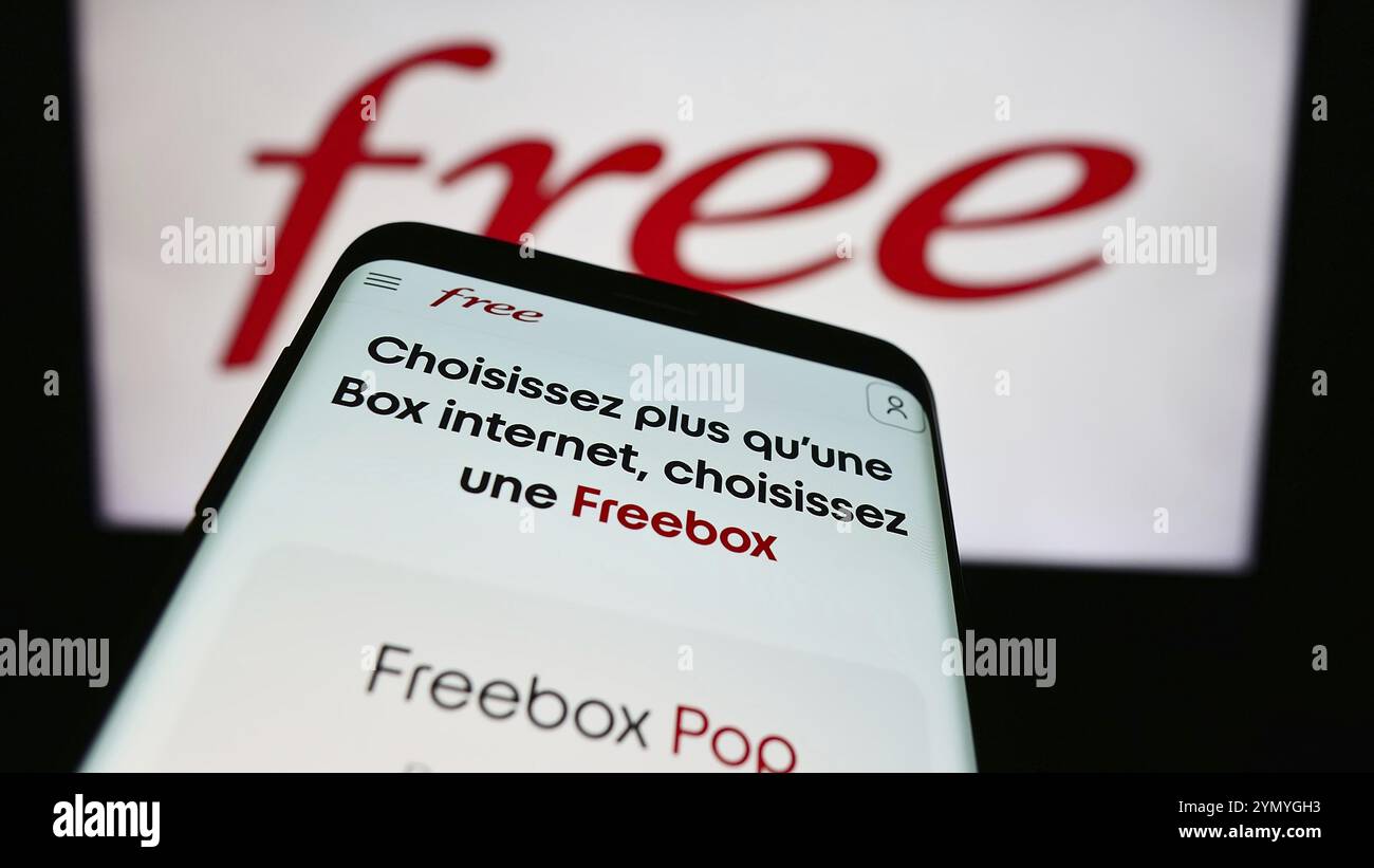 Stuttgart, Germany, 05-23-2024: Smartphone with website of French telecommunications company Free S.A.S. in front of business logo. Focus on top-left Stock Photo