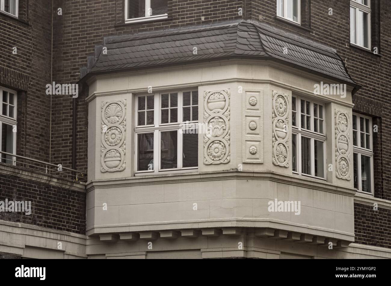 Windows with decorations of an office building over 100 years old Stock Photo