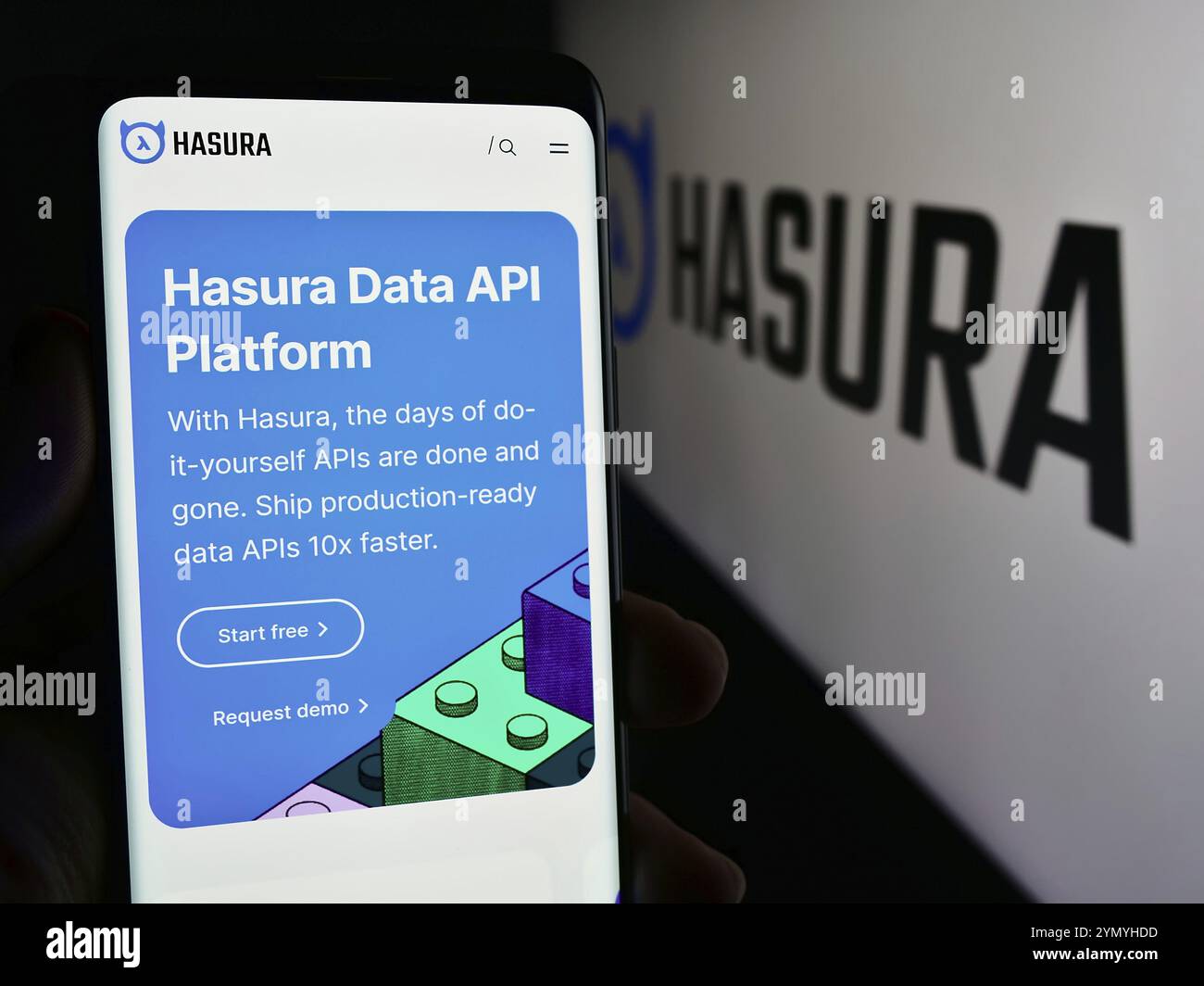 Stuttgart, Germany, 05-07-2024: Person holding mobile phone with web page of US software development company Hasura Inc. in front of logo. Focus on ce Stock Photo