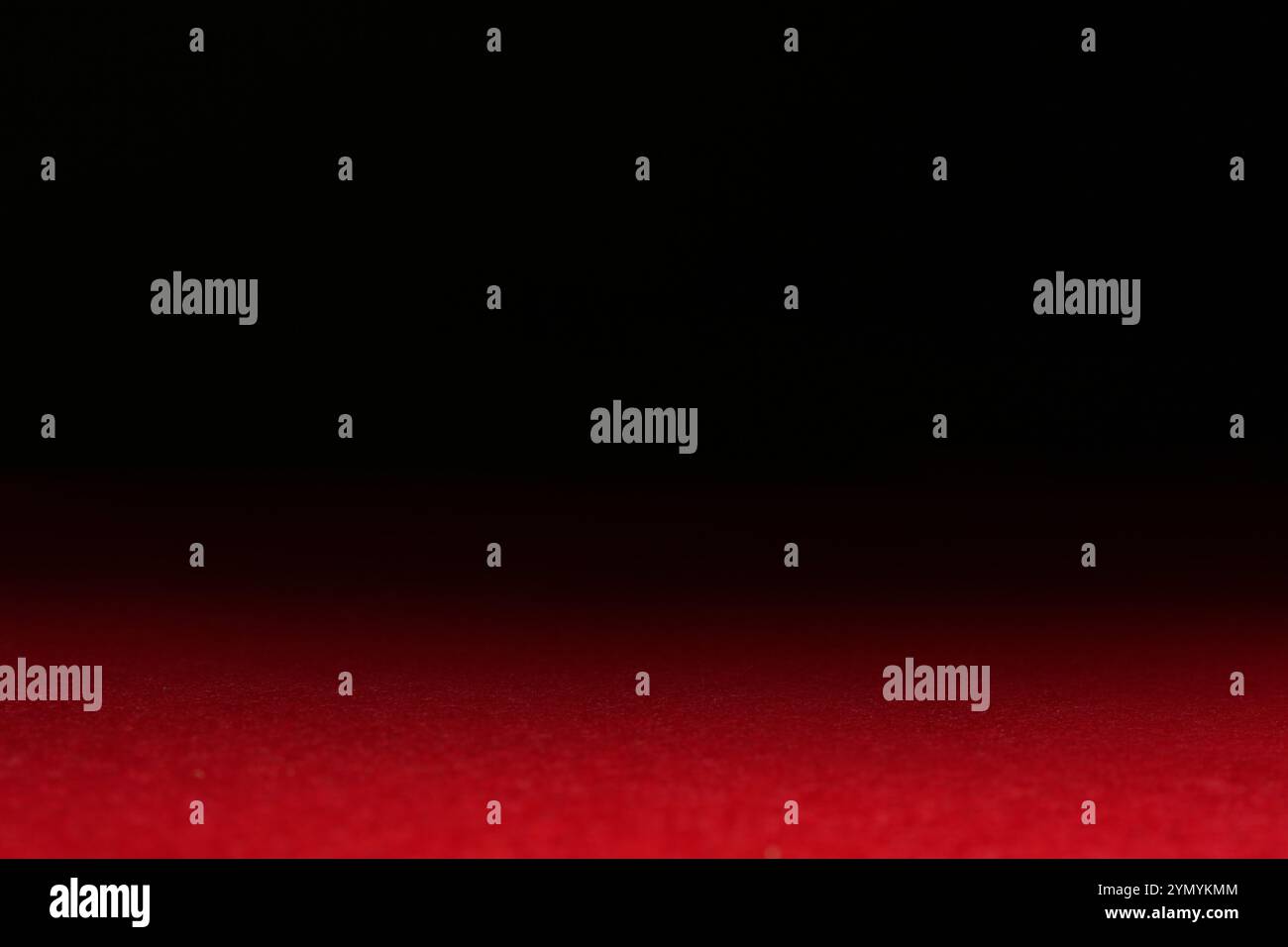 Red textured surface against dark background, selective focus Stock Photo