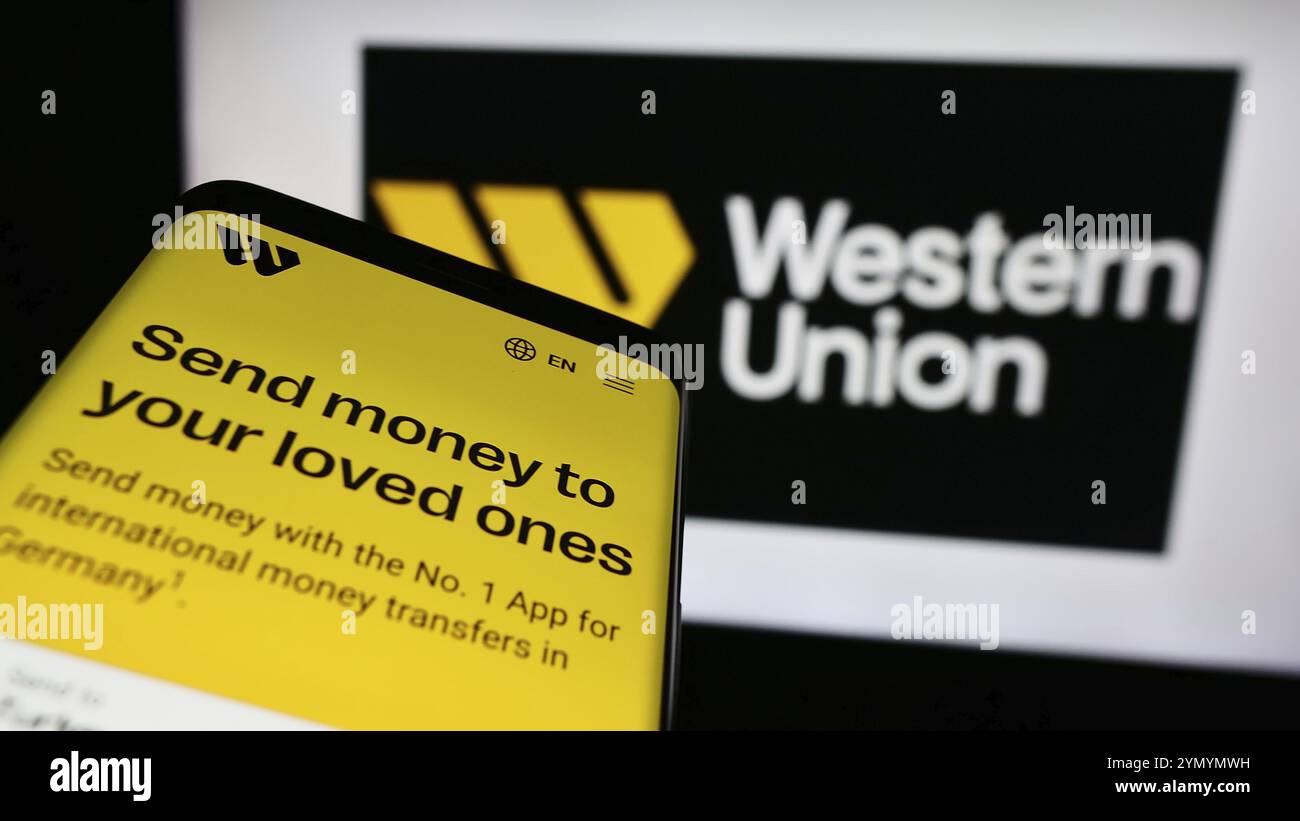 Stuttgart, Germany, 05-27-2024: Mobile phone with web page of US financial services business The Western Union Company in front of logo. Focus on top- Stock Photo