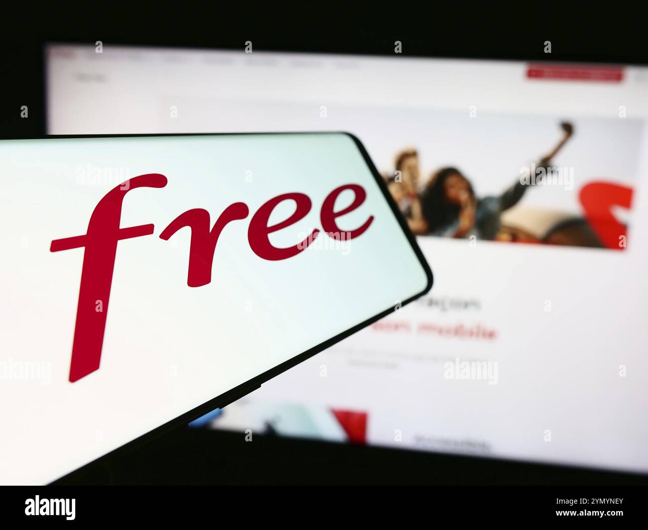 Stuttgart, Germany, 05-23-2024: Mobile phone with logo of French telecommunications company Free SAS in front of business website. Focus on center-lef Stock Photo