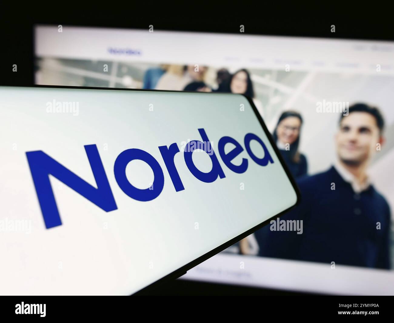 Stuttgart, Germany, 03-15-2024: Mobile phone with logo of Finnish financial services company Nordea Bank Abp in front of website. Focus on center-righ Stock Photo