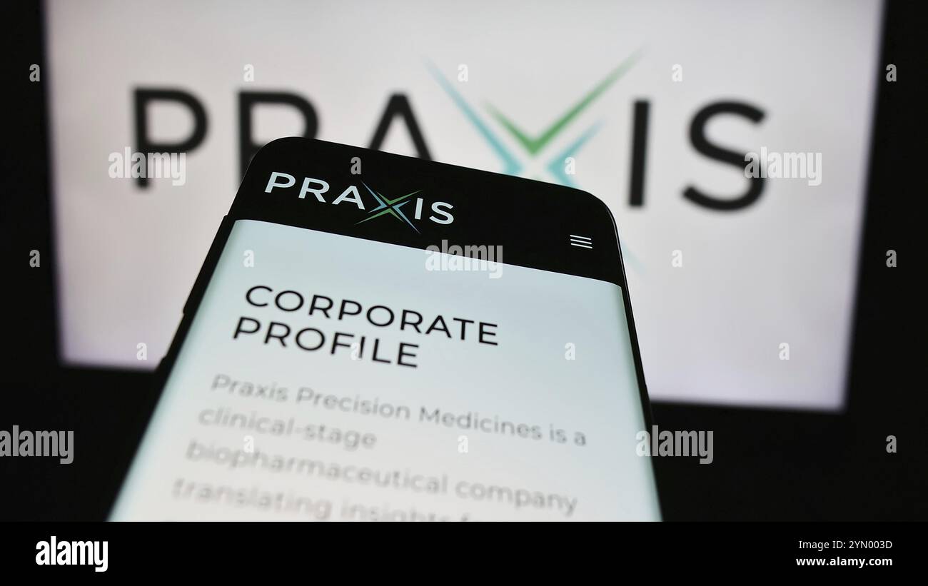 Stuttgart, Germany, 04-28-2024: Mobile phone with webpage of US biopharma company Praxis Precision Medicines Inc. in front of business logo. Focus on Stock Photo