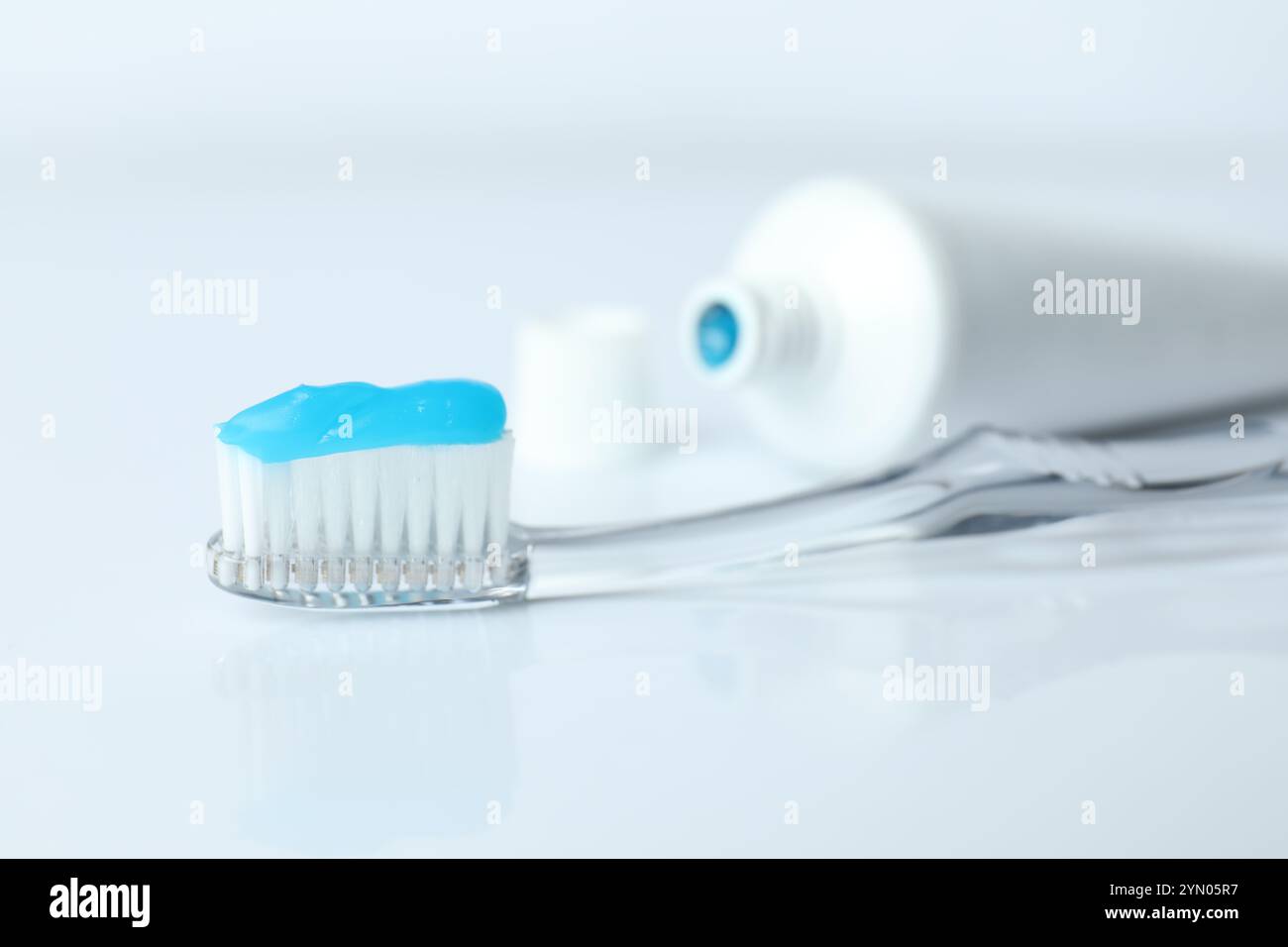 Toothbrush with toothpaste and tube on white background Stock Photo - Alamy